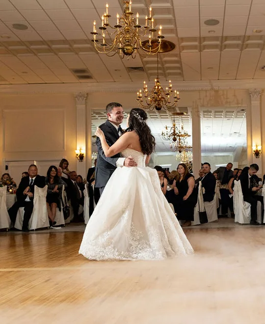 Newlywed couple dances as mist permeates across the dance floor