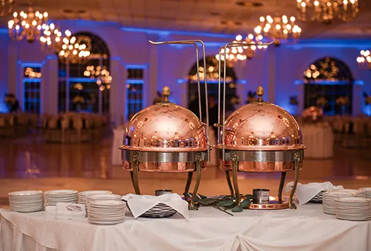 Covered food platters with dance floor in the background