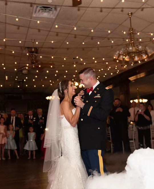 Bride and groom in military attire dancing